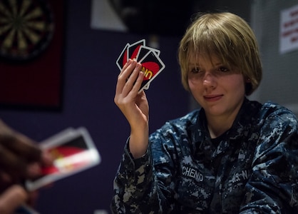 Electricians Mate Michelle Schend, Naval Nuclear Power Training Command student, plays a card game with fellow Sailors in the Bowman Center Feb. 9, 2015, at Joint Base Charleston – Weapons Station. NNPTC students undergo rigorous schooling to learn about the operation, maintenance and supervision of naval nuclear propulsion plants. (U.S. Air Force photo/ Senior Airman Dennis Sloan)