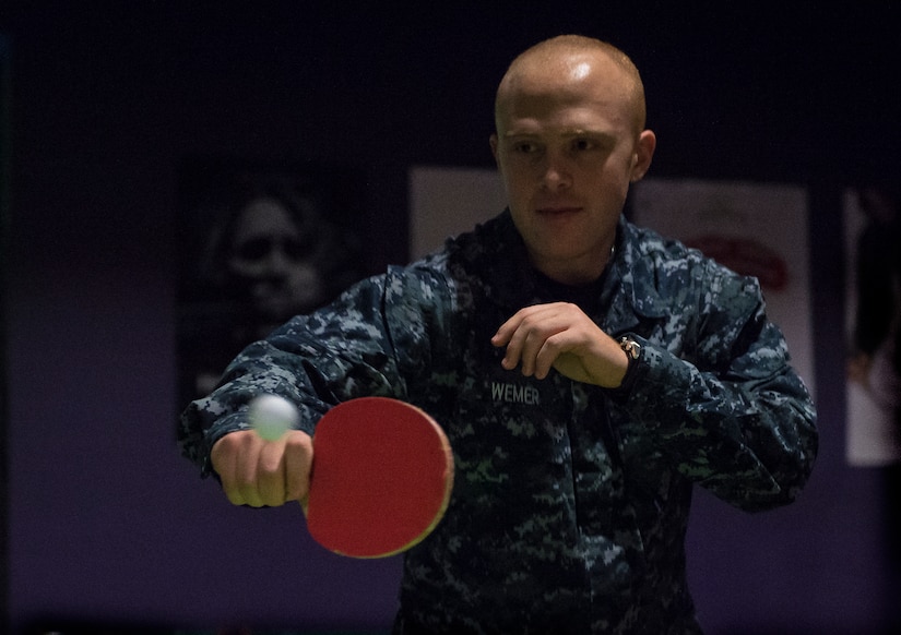 Machinist Mate Chris Wemer, Naval Nuclear Power Training Command student, plays a game of ping pong in the Bowman Center Feb. 9, 2015, at Joint Base Charleston – Weapons Station. Wemer recently graduated from Navy boot camp and is now attending a six-month long course at NNPTC to learn about the operation, maintenance and supervision of naval nuclear propulsion plants. NNPTC is famous for the rigour of its classes, making the activities at the Bowman Center a welcome source of relief for many Sailors. (U.S. Air Force photo/ Senior Airman Dennis Sloan)