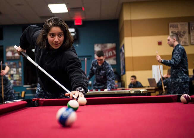 Electricians Mate Stacey DeLacruz, Naval Nuclear Power Training Command student, plays a game of pool in the Bowman Center Feb. 9, 2015, at Joint Base Charleston – Weapons Station. DeLacruz recently graduated from Navy boot camp and is now attending a six-month long course at NNPTC to learn about the operation, maintenance and supervision of naval nuclear propulsion plants. NNPTC is famous for the rigour of its classes, making the activities at the Bowman Center a welcome outlet for many Sailors.  (U.S. Air Force photo/ Senior Airman Dennis Sloan)