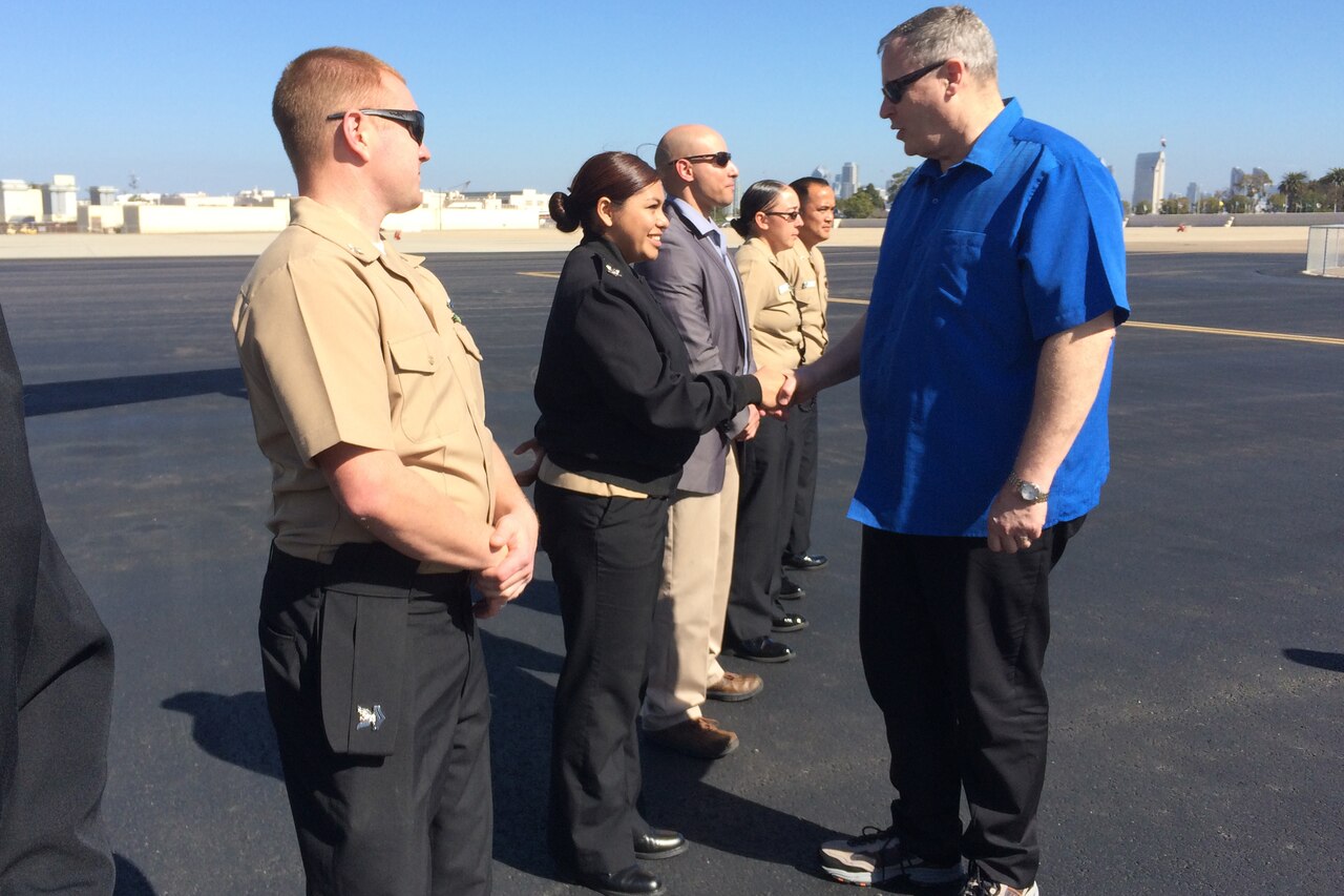 Deputy Defense Secretary Bob Work shakes hands with service members as he prepares to depart Naval Air Station North Island, San Diego, Feb. 10, 2015. While in San Diego, Work attended the U.S. Naval Institute's 2015 Western Conference and Exposition, and later visited the Navy’s newest mobile landing platform under construction. DoD photo by Claudette Roulo