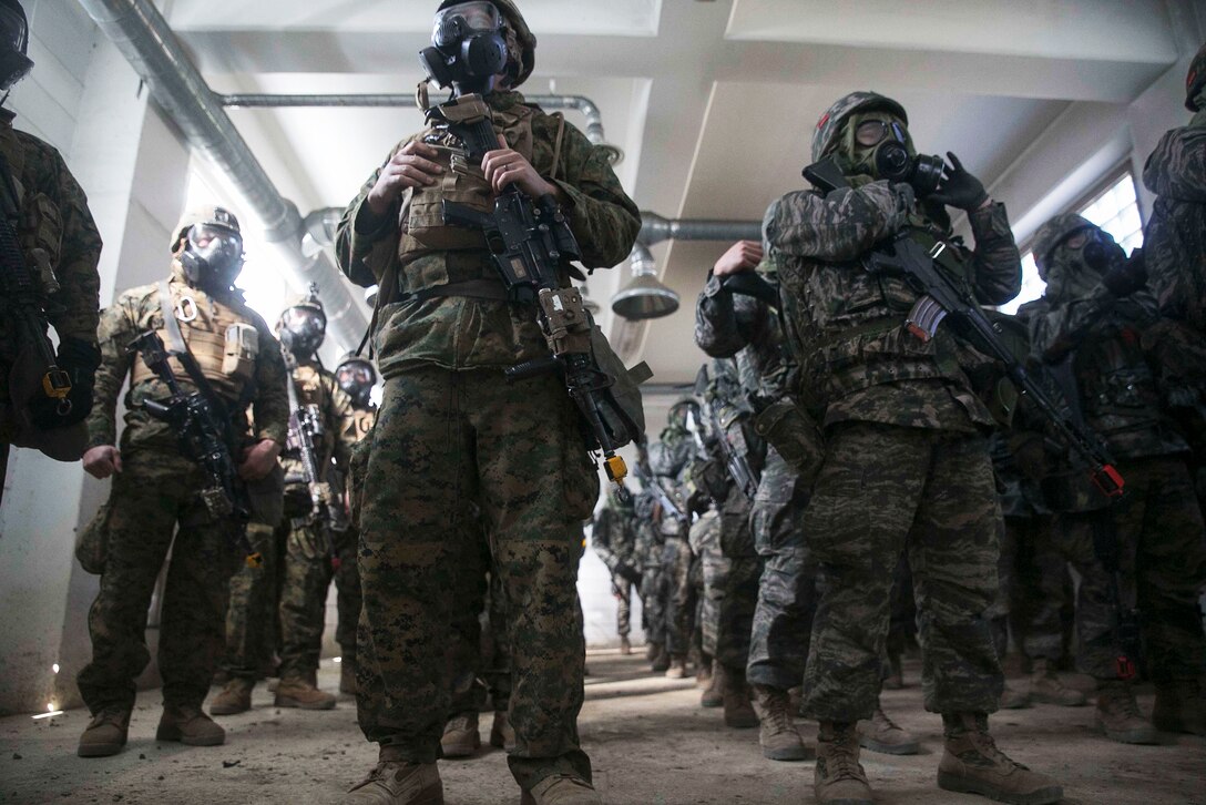 South Korean and U.S. Marines stand inside of a gas exposure training chamber during the Korean Marine Exchange Program 15-17 on the Cham Sae Mi Close-Quarters Battle Training Facility in Pohang, South Korea, Feb. 9, 2015. 