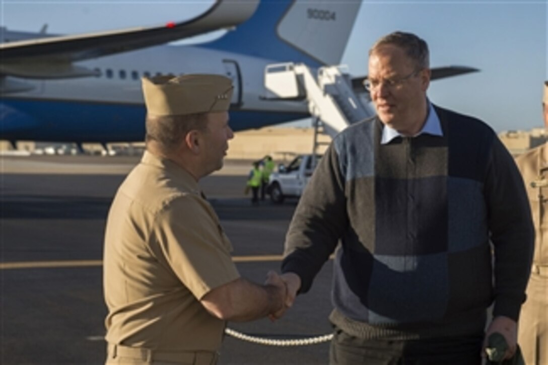 Vice Adm. Kenneth Floyd, left, Commander, U.S. Third Fleet welcomes Deputy Defense Secretary BoB Work to Naval Air Station North Island as he arrives to attend the U.S. Naval Institute 2015 West Conference in San Diego, Calif., Feb 9, 2015. 