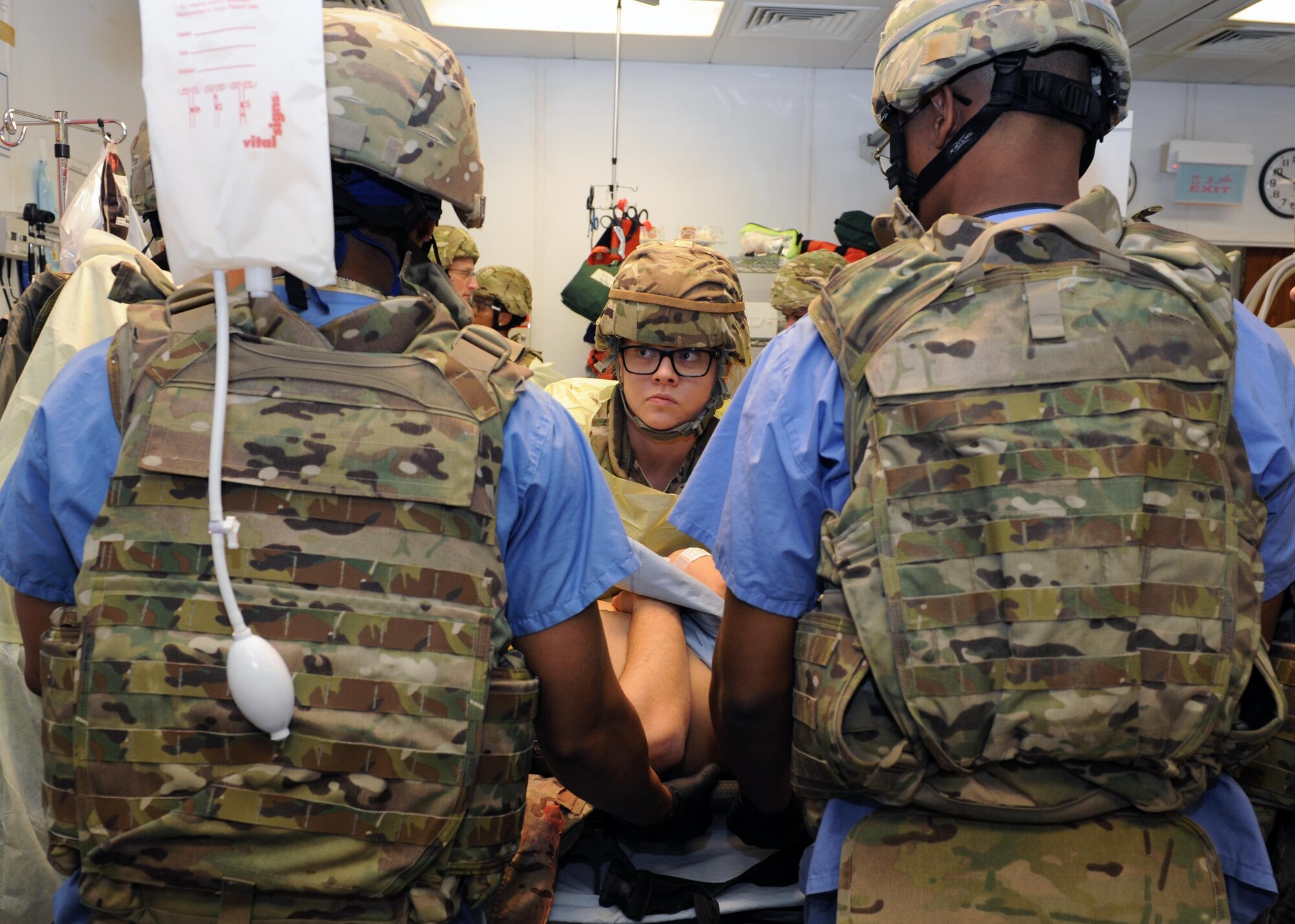 U.S. Air Force Airmen assigned to the 455th Expeditionary Medical Group prepare to lift a simulated patient in order to perform an initial assessment during a base exercise Feb. 6, 2015 at Bagram Airfield, Afghanistan. The exercise tested the defensive posture and emergency response preparedness of U.S. and coalition forces here. (U.S. Air Force photo by Staff Sgt. Whitney Amstutz/released)