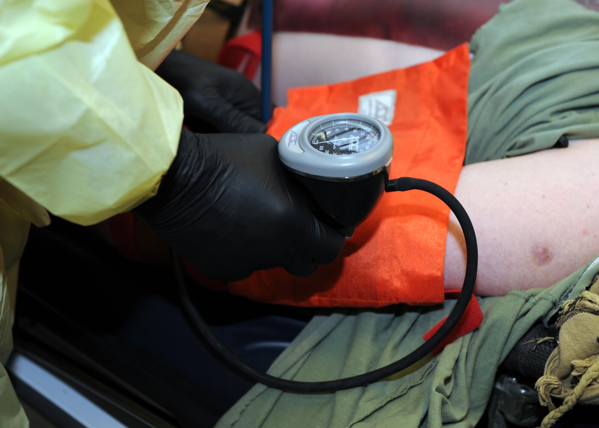 A U.S. Air Force Airman assigned to the 455th Expeditionary Medical Group simulates taking the vital signs of an exercise role-player in the emergency room of the Craig Joint Theater Hospital during an exercise Feb. 6, 2015 at Bagram Airfield, Afghanistan. The exercise tested the defensive posture and emergency response preparedness of U.S. and coalition forces here. (U.S. Air Force photo by Staff Sgt. Whitney Amstutz/released)