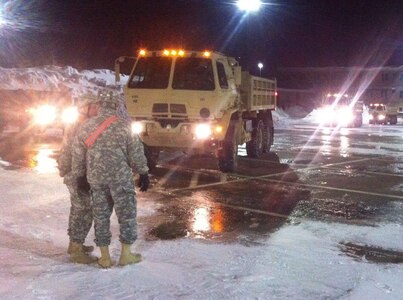 Soldiers from the Massachusetts National Guard's 181st Engineers from Joint Base Cape Cod stage vehicles at the high school in Weymouth in response to record snowfalls over the past few weeks. The 181st was called upon by local authorities to assist with snow removal. 