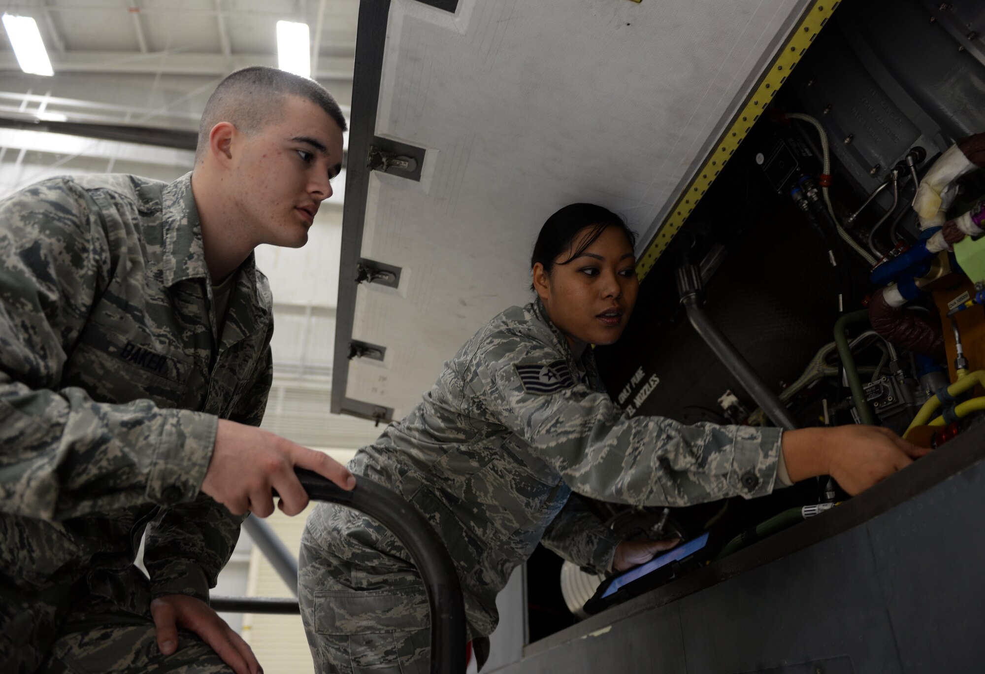 Tech. Sgt. Maureen Madamba (right), 372nd Training Squadron Detachment 21 maintenance instructor, instructs Airman Basic Lain Baker, 372nd TRS Detachment 21 student, how to properly inspect interior components of a RQ-4 Global Hawk Jan. 20, 2015, at Beale Air Force Base, Calif. Madamba is tasked with teaching the first class of the RQ-4 remotely piloted aircraft maintenance course. (U.S. Air Force photo by Senior Airman Bobby Cummings)
