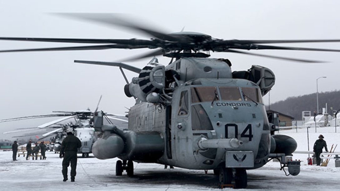 Marines with Marine Heavy Helicopter Squadron 464 execute their pre-flight inspection on a CH-53 Super Stallion during their deployment for training exercise aboard Camp Dawson, West Virginia, Jan. 30, 2015. The squadron arrived at Camp Dawson, Jan. 30 for their DFT and spent approximately two weeks learning how to conduct aerial operations in a colder environment than they are used to.