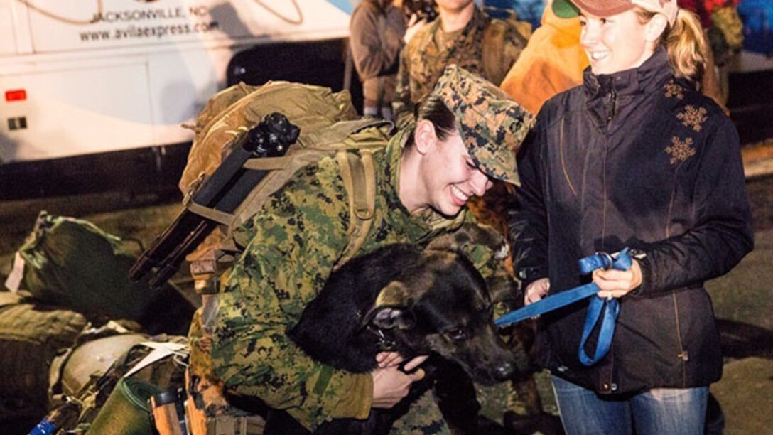 Friends and pets are united during a homecoming aboard Camp Lejeune, N.C., Feb. 5, 2015. 1st Lt. Maida Kalic (center) returned from a six-month deployment in support of Special Purpose Marine Air-Ground Task Force Crisis Response-Africa.