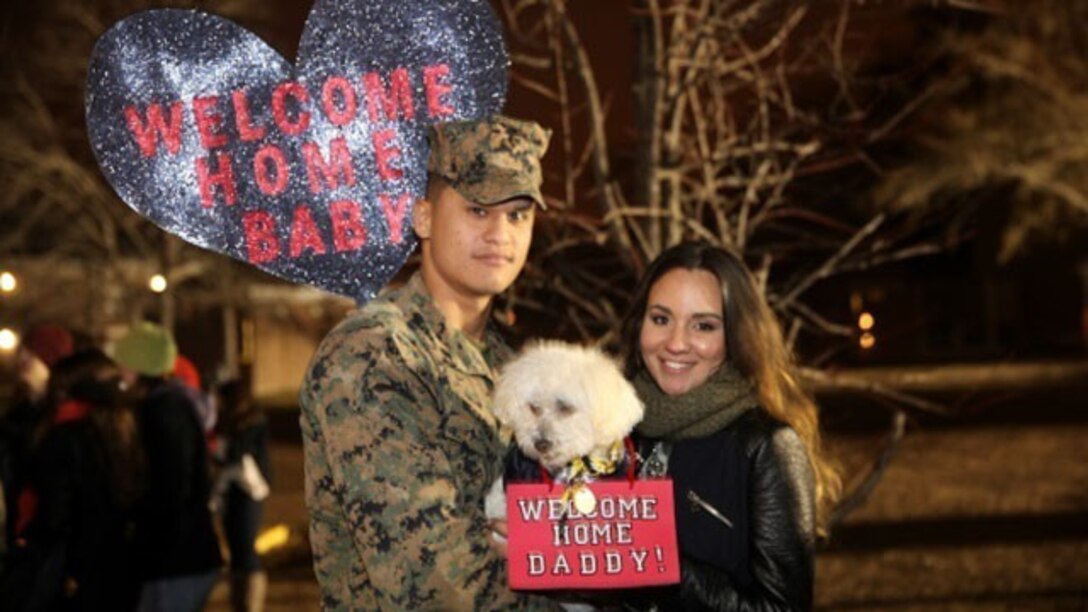 Corporal Jose Becerra poses for a photo with his wife during a homecoming event aboard Camp Lejeune, N.C., Jan. 14, 2015. Becerra returned from a six-month deployment in support of Special Purpose Marine Air-Ground Task Force Crisis Response-Africa. 