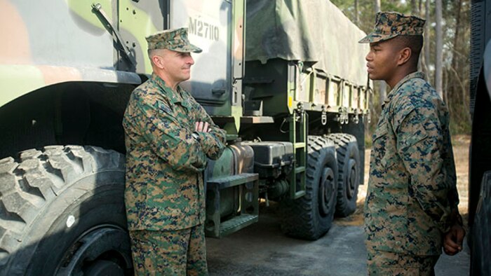Brig. Gen. Charles G. Chiarotti, left, Commanding General, 2nd Marine Logistics Group, speaks with Cpl. David A. Fowler, a motor vehicle operator with Marine Air Ground Task Force Materiel Distribution Company, following the company’s activation ceremony, Feb. 9, 2015, aboard Camp Lejeune, North Carolina. Fowler and other Marines with the company discussed the unit’s capabilities with Chiarotti. The company has been created within 2nd Supply Battalion, Combat Logistics Regiment 25, 2nd Marine Logistics Group, to establish a proof of principle on the reorganization of intermediate supply and distribution capabilities in order to provide tailored capabilities to units deploying in support if the II Marine Expeditionary Force. The integration of personnel in the new company will enhance the unit’s ability to support outside units, with no changes to garrison support operations or deployed support operations.