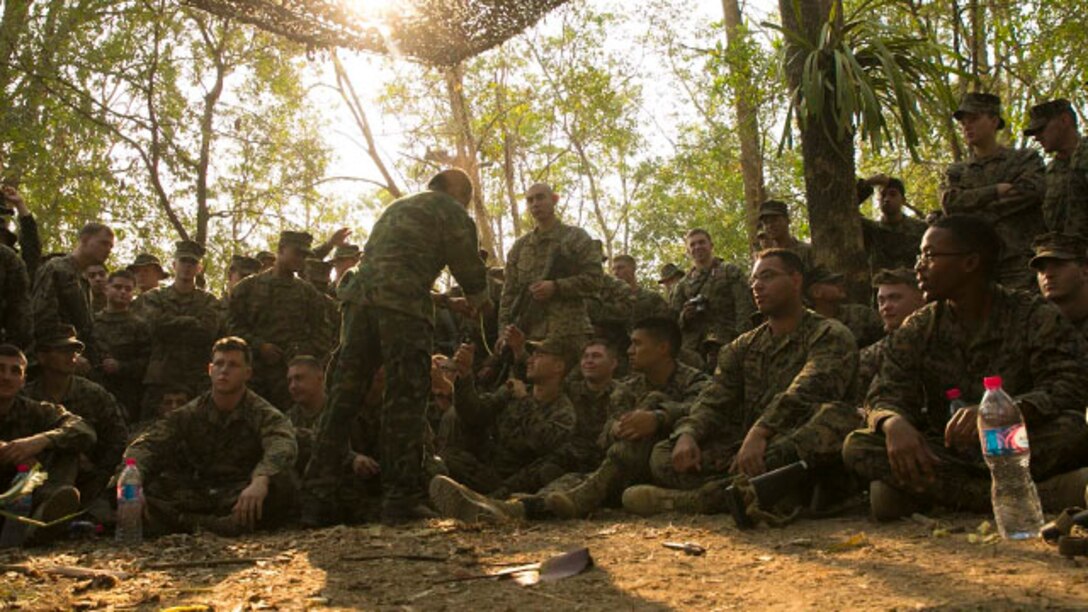 U.S. Marines patiently wait for their turn to get a taste of fruit Feb. 8 at Ban Chan Khrem, Thailand, during exercise Cobra Gold 2015. The Royal Thai Marines gave the U.S. Marines a taste of Thailand by sharing fruit commonly found in the local jungle. The Marines are with III Marine Expeditionary Force.