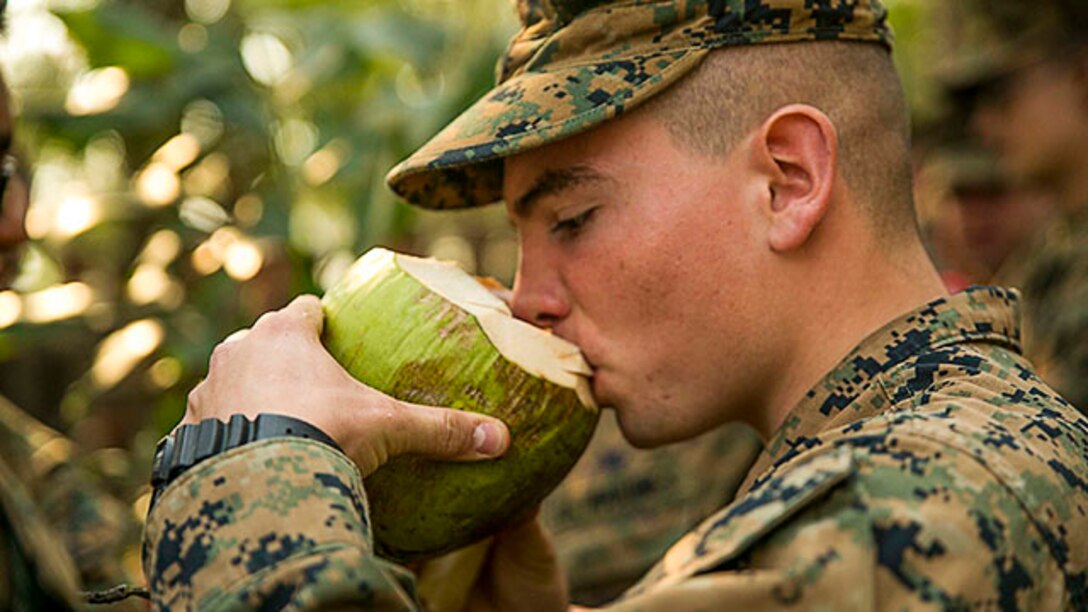 Lance Cpl. James Hutsell, from Fayetteville, N.C., drinks coconut water Feb. 8 at Ban Chan Krem, Thailand, during exercise Cobra Gold 2015. The Royal Thai Marines shared several of their native fruits found in the jungle with U.S. Marines. Hutsell is a radio operator with 1st Battalion, 1st Marine Regiment, currently assigned to 4th Marine Regiment under the unit deployment program.