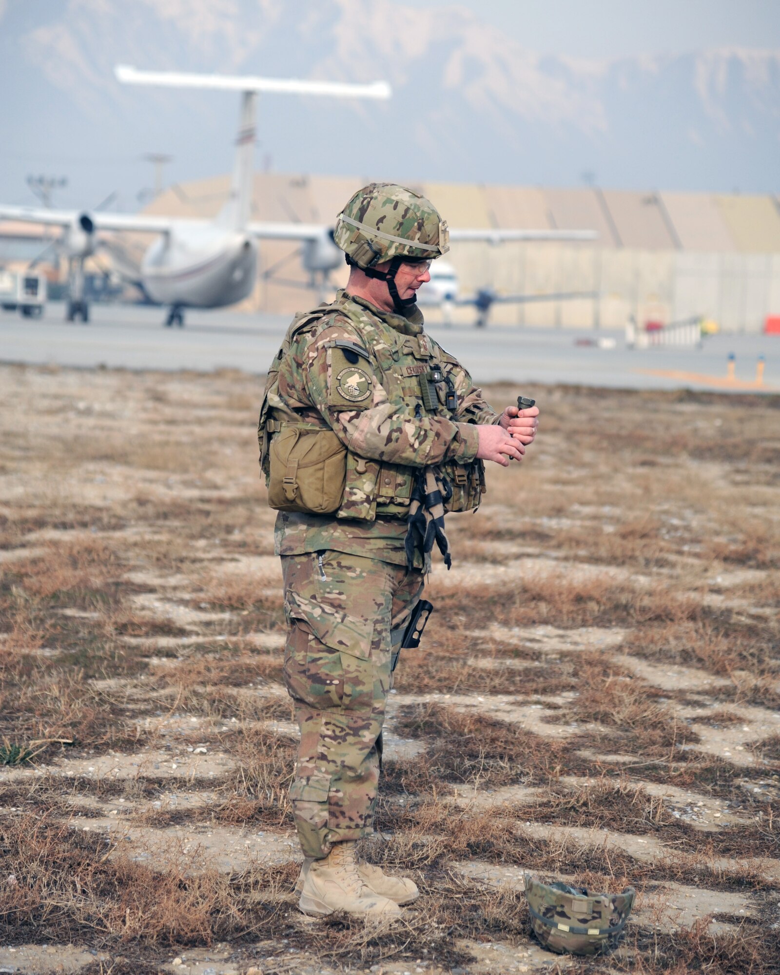 U.S. Air Force Master Sgt. Christopher Cekovsky, 455th Expeditionary Security Forces Squadron, pulls the pin on a flash-bang grenade during a combined-joint training exercise at Bagram Airfield, Afghanistan Feb. 6, 2015. U.S. and Georgian service members participated in the base-wide exercise enhancing their abilities to respond in the event of attacks on the base and mass casualty incidents.  (U.S. Air Force photo by Master Sgt. James Law/released)