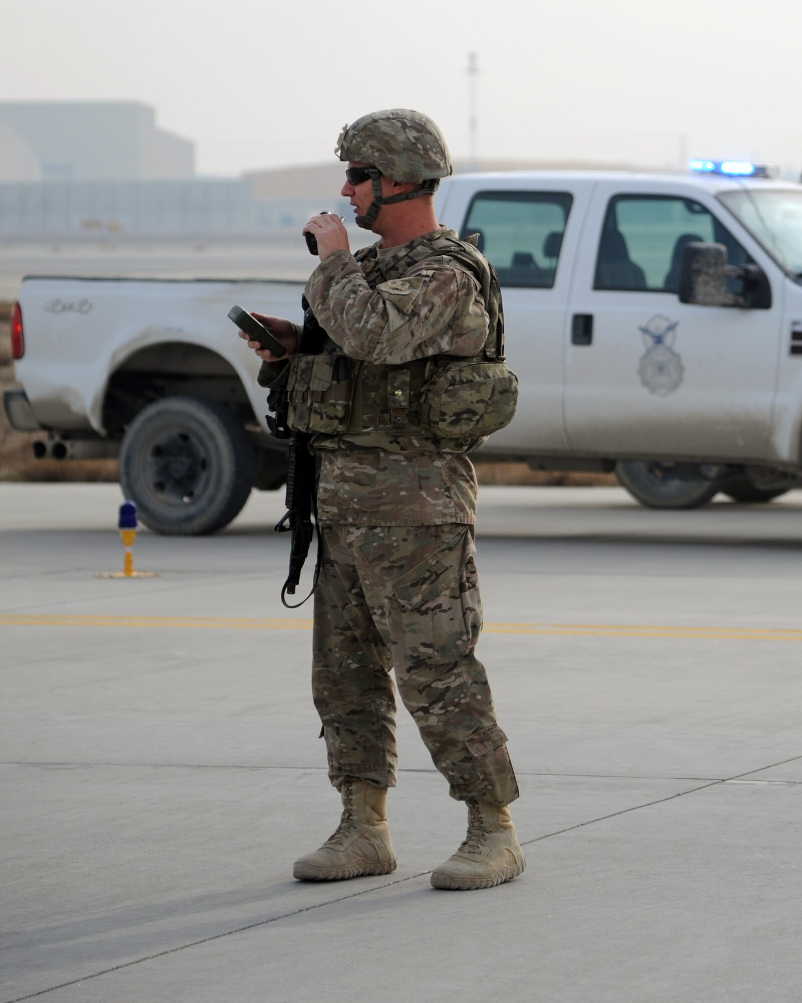 U.S. Air Force Technical Sgt. Edwin Bowser, 455th Expeditionary Security Forces Squadron, sets up a cordon on the flightline during a combined-joint training exercise at Bagram Airfield, Afghanistan Feb. 6, 2015. U.S. and Georgian service members participated in the base-wide exercise enhancing their abilities to respond in the event of attacks on the base and mass casualty incidents.  (U.S. Air Force photo by Master Sgt. James Law/released)