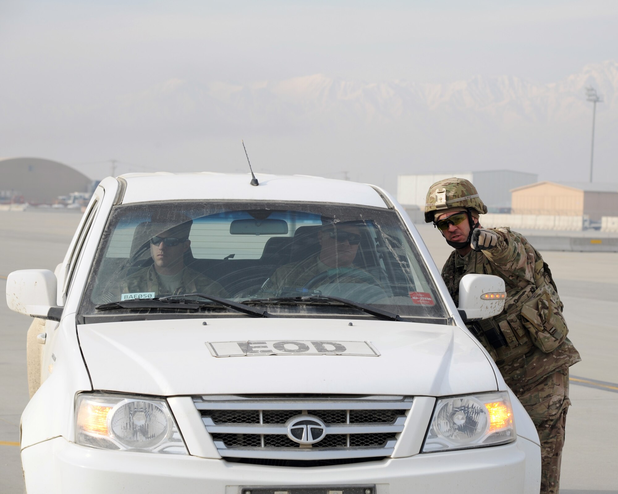 U.S. Air Force Technical Sgt. John Roach, 455th Expeditionary Security Forces Squadron, directs Explosive Ordinance Disposal personnel to a simulated indirect fire impact sight on the flightline during a combined-joint training exercise at Bagram Airfield, Afghanistan Feb. 6, 2015. U.S. and Georgian service members participated in the base-wide exercise enhancing their abilities to respond in the event of attacks on the base and mass casualty incidents.  (U.S. Air Force photo by Master Sgt. James Law/released)