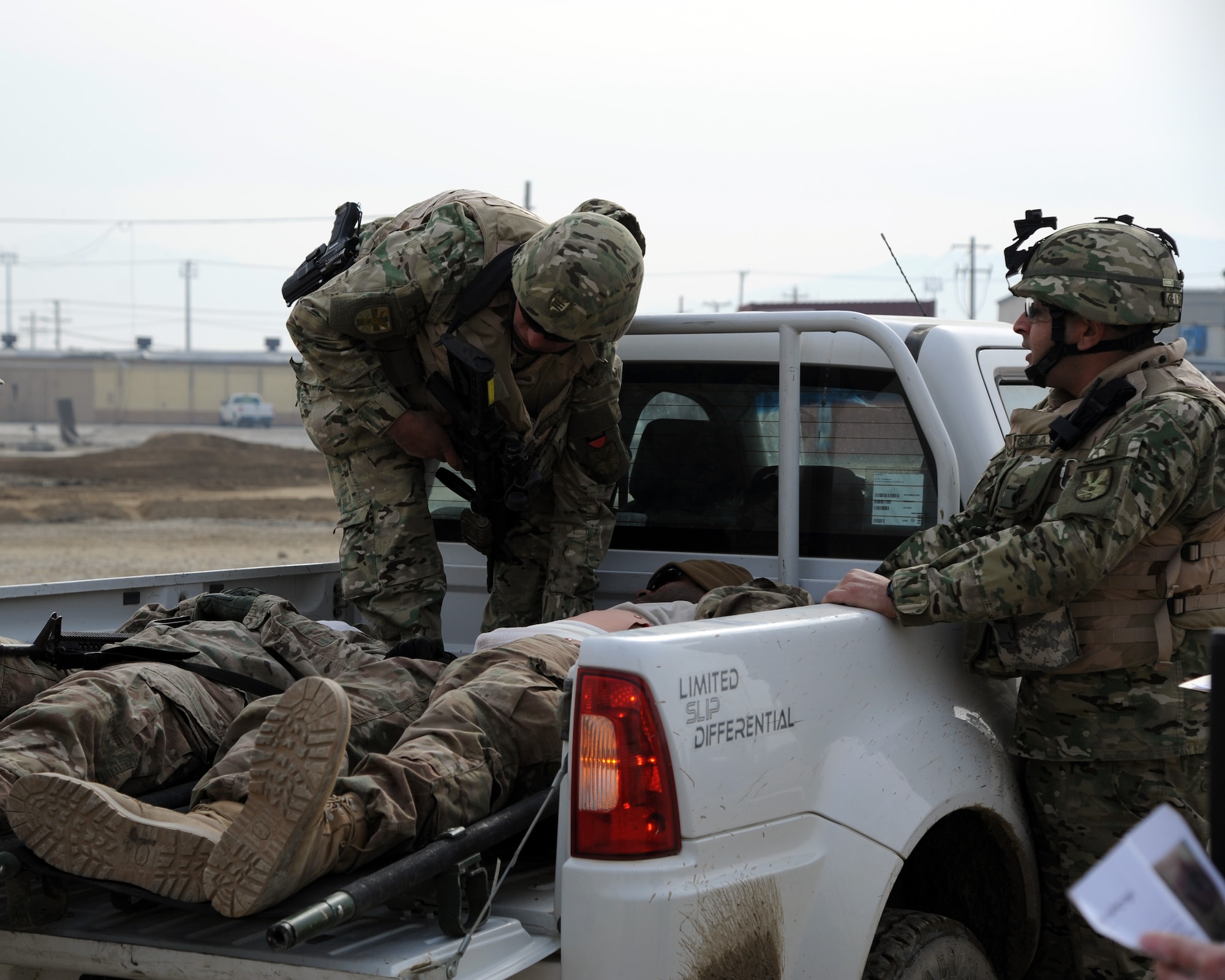 Georgian servicemen provide first aid during a combined-joint training exercise at Bagram Airfield, Afghanistan Feb. 6, 2015. U.S. and Georgian service members participated in the base-wide exercise enhancing their abilities to respond in the event of attacks on the base and mass casualty incidents.  (U.S. Air Force photo by Master Sgt. James Law/released)