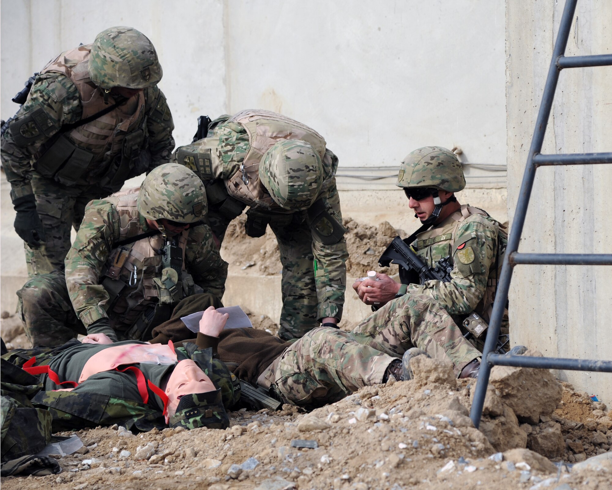 Georgian servicemen provide first aid during a combined-joint training exercise at Bagram Airfield, Afghanistan Feb. 6, 2015. U.S. and Georgian service members participated in the base-wide exercise enhancing their abilities to respond in the event of attacks on the base and mass casualty incidents.  (U.S. Air Force photo by Master Sgt. James Law/released)