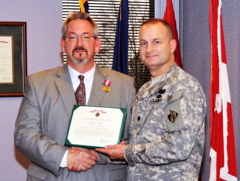 Tracey Shaw, of the Engineering and Support Center, Huntsville, receives the Barbara C. Heald (Deployed civilian) Special Award and Superior Civilian Service Award from Huntsville Center deputy commander Lt. Col. Kendall Bergmann.  