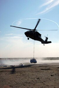 A UH-60 Blackhawk helicopter belonging to the 1/244th Assault Helicopter Battalion, State Aviation Command, Louisiana Army National Guard performs sling-load operations in support of the state of Louisiana's response to the Deepwater Horizon, in Hammond, La., May 11, 2010. 