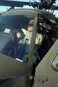 Missouri National Guard Capt. Nicholas Pianalto makes equipment adjustments in the pilot's seat of a UH-60 Black Hawk helicopter on the air field of the Christopher S. “Kit” Bond Army Aviation Support Facility at Fort Leonard Wood. Pianalto, who lives in Waynesville, and three other Missouri Guardsman took off from Fort Leonard Wood to help with the response to the oil spill in the Gulf of Mexico May 26, 2010.