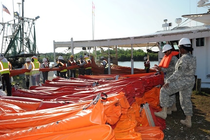 Sgt. Theron Corey and Sgt. Jaquia Jones, both of the Louisiana National
Guard's 1022nd Engineer Company, 527th Engineer Battalion, record the amount
of outgoing hard boom at Breton Sound Marina in Hopedale, La., on May 27,
2010, in support of the Deepwater Horizon oil spill cleanup efforts.
Incoming supplies include hard booms, soft booms, absorbent pads, pompoms
and peat moss.