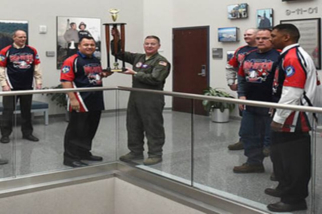 The NORAD-USNORTHCOM silver softball team presented their base championship trophy to Lt. Gen. Michael Dubie, deputy commander United States Northern Command, and vice commander, U.S. Element, North American Aerospace Defense Command here Feb. 2, 2015.