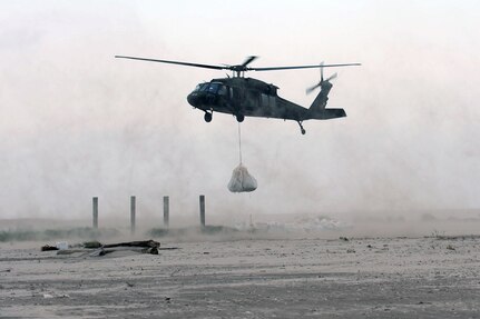 UH-60 Blackhawk helicopters belonging to the 1/244th Assault Helicopter Battalion, State Aviation Command of the Louisiana Army National Guard sling load several thousand pound sandbags to Trinity Island to fill in a low lying area critical to oil spill mitigation efforts along Louisiana’s shoreline in Hammond, La., May 27, 2010. Trinity Island is one of many barrier islands along the coast of Louisiana that are threatened by the oil spill.