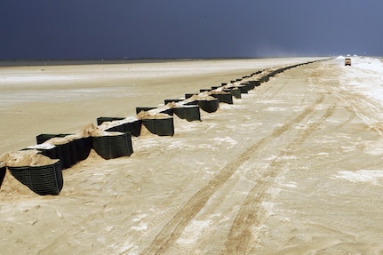 Soldiers of the Louisiana National Guard’s 527th and 769th Engineer Battalions complete wall of sand-filled Hesco Concertainer units in Port Fourchon, La., to help keep oil tainted water from reaching Bay Champagne near Port Fourchon, La., May 29, 2010.