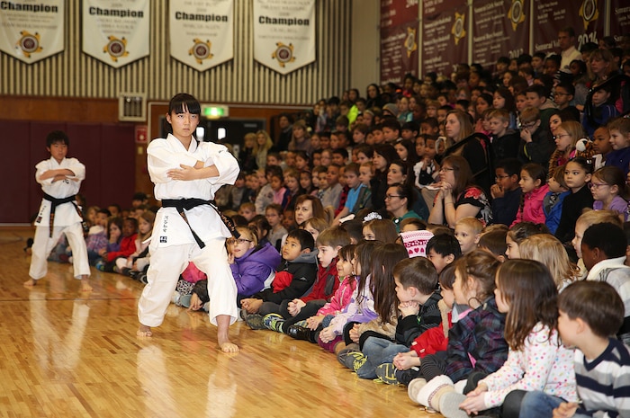 Dressed in their karate-gi, a Japanese karate training uniform, the Shunan International Children’s Club demonstrates a sequence of traditional martial arts techniques during Matthew C. Perry Elementary School’s Japanese Cultural Exchange aboard Marine Corps Air Station Iwakuni, Japan, Feb. 11, 2015. The 5th annual exchange included traditional martial arts, a classical Japanese dance and musical performances.  