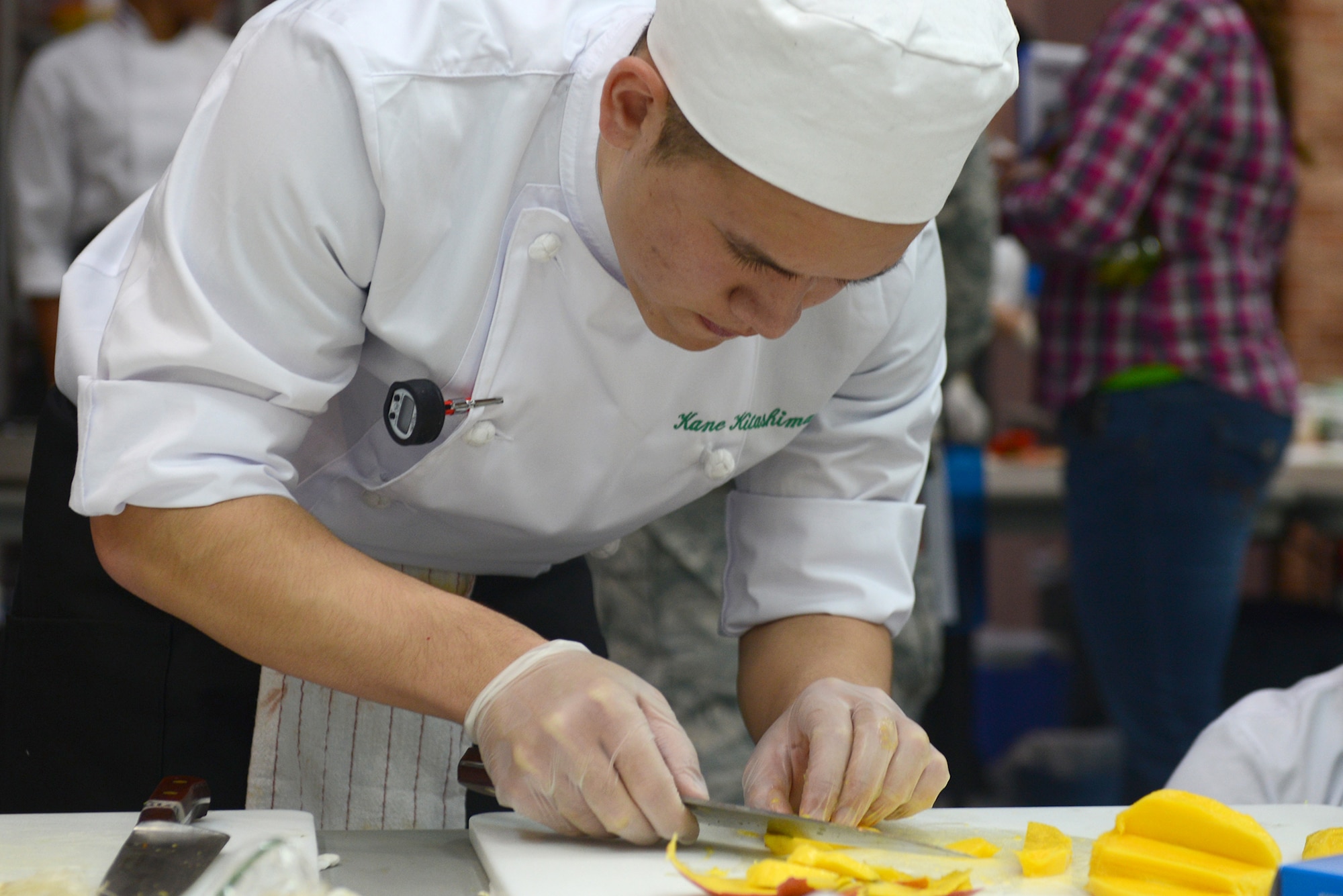 A student from Edgren High School slices fruit during the 2015 Far East Culinary Arts competition at Yokota Air Base, Japan, Feb. 5, 2015. The competition showcases the talents of students representing the Department of Defense Education Activity Pacific high school culinary arts programs. (U.S. Air Force photo by Airman 1st Class David C. Danford/Released)