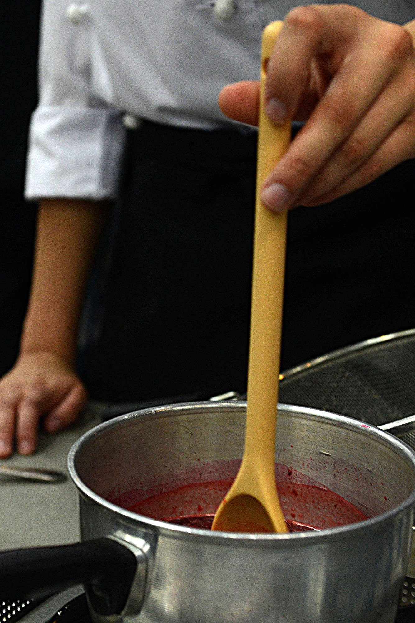 A Kubasaki High School student uses a ladle during the  2015 Far East Culinary Arts competition at Yokota Air Base, Japan, Feb. 5, 2015. The competition showcases the talents of students representing the Department of Defense Education Activity Pacific high school culinary arts programs. (U.S. Air Force photo by Airman 1st Class David C. Danford/Released)