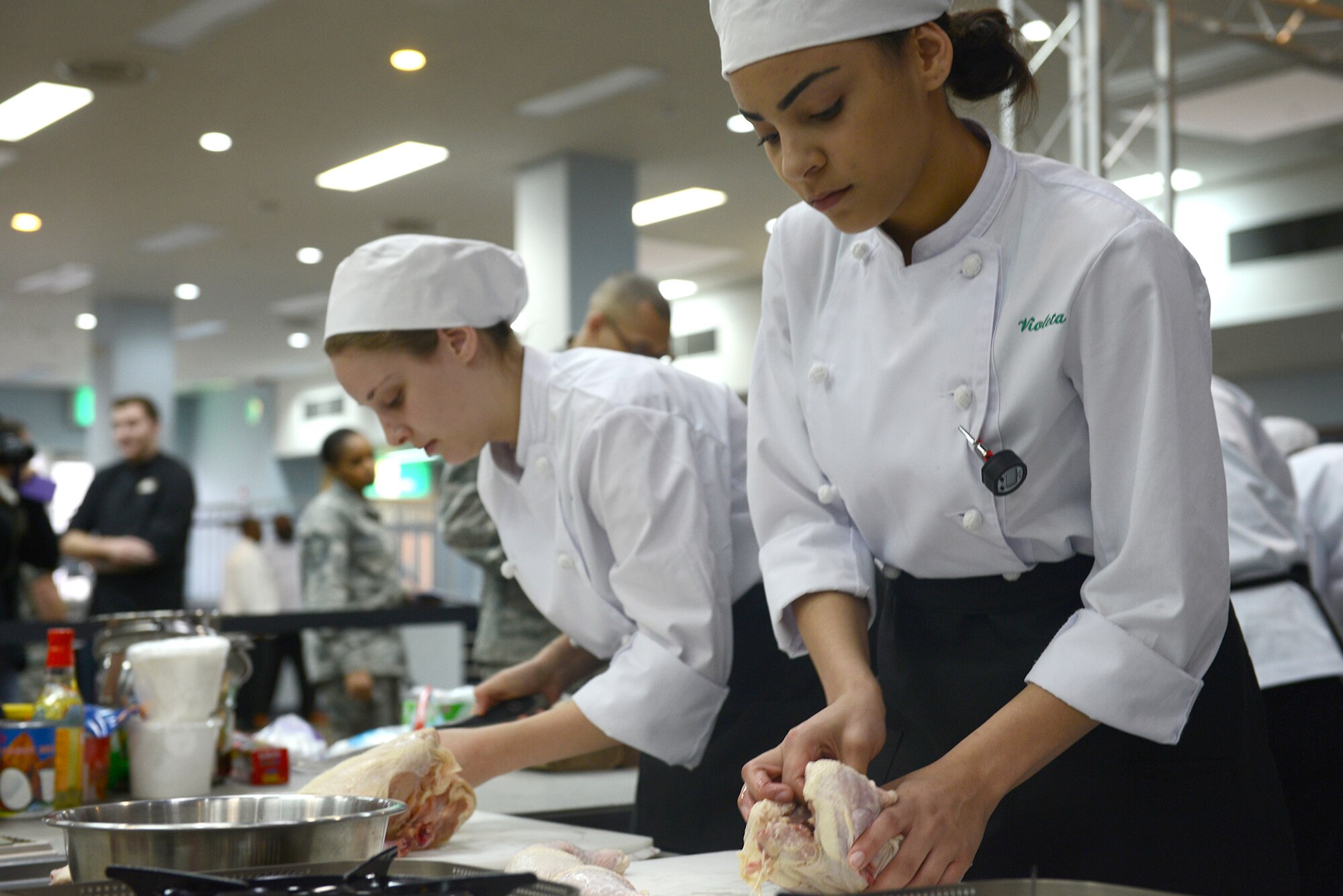 Students from Kubasaki High School prepare chicken during the 2015 Far East Culinary Arts competition at Yokota Air Base, Japan, Feb. 5, 2015. Teams of four students were given one hour to prepare a three-course meal using only two butane burners. (U.S. Air Force photo by Airman 1st Class David C. Danford/Released)