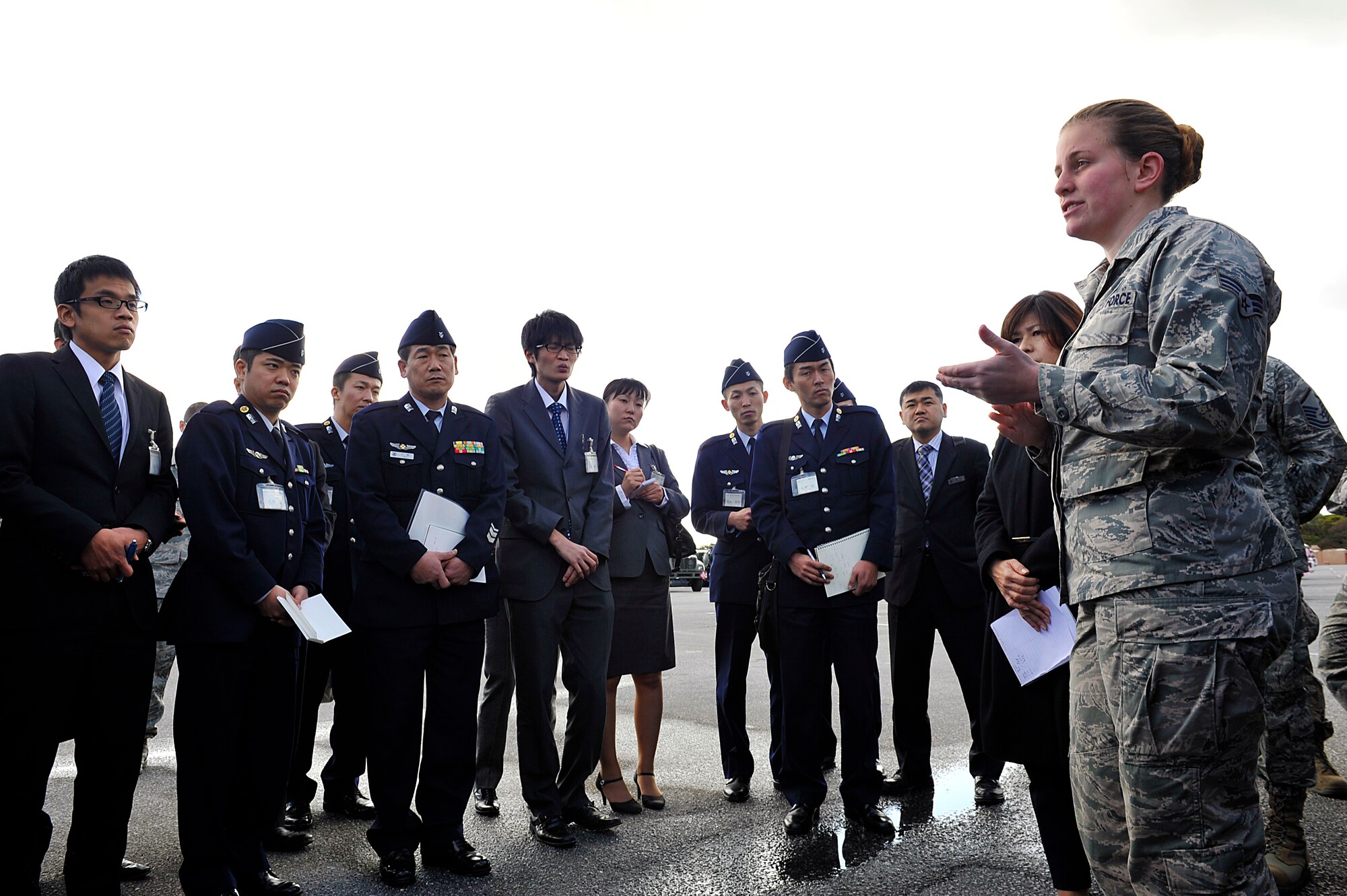 U.S. Air Force Senior Airman Jennifer Barnett, 18th Logistics Readiness Squadron fuels hydrants operator, explains an R-12 gas truck's functions to Japan Air Self Defense Force members during their visit to Kadena Air Base, Okinawa, Japan, Feb. 10, 2015. Twenty-six JASDF members visited from the 151th Basic Supply Course, 3rd Technical School, Ashiya Base, Fukuoka, to learn the U.S. Air Force side of supply system. (U.S. Air Force photo by Naoto Anazawa)