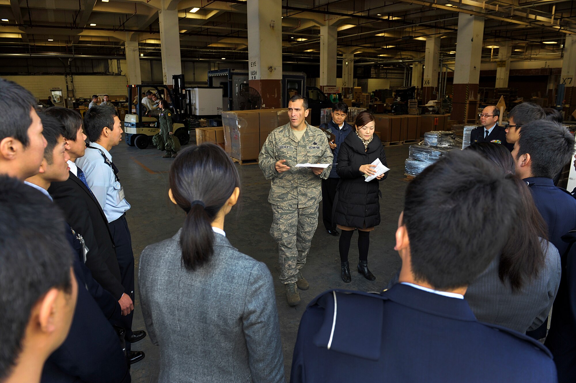 U.S. Air Force Master Sgt. Jaime Davilaramirez, 18th Logistics Readiness Squadron NCO in charge of flight service center, explains to Japan Air Self Defense Force members how the 18th LRS flight service center warehouse processes and handles both reparable and consumable parts before sending them to the transportation management office during a JASDF visit to Kadena Air Base, Okinawa, Japan, Feb. 10, 2015. The JASDF members had the opportunity to learn about the 18th LRS supply facility and also visited the 733rd Air Mobility Squadron and 18th Munitions Squadron. (U.S. Air Force photo by Naoto Anazawa)