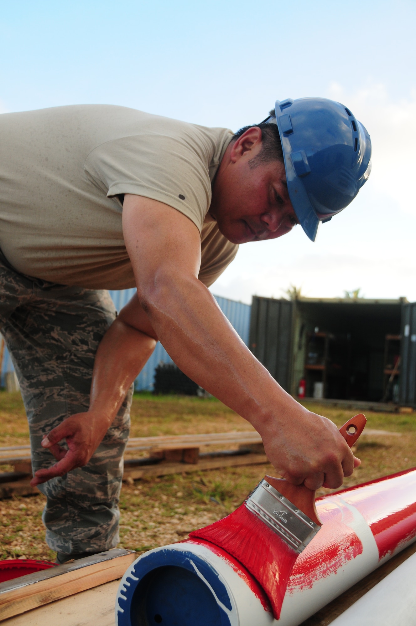 U.S. Air National Guard Master Sgt. Gill Vicente with the 146th Airlift Wing Civil Engineering Squadron paints pipes to be installed at the 554th Red Horse Squadron, Andersen Air Force Base, Guam on January 30, 2015. (U.S. Air National Guard photo by Airman 1st Class Madeleine Richards/Released)