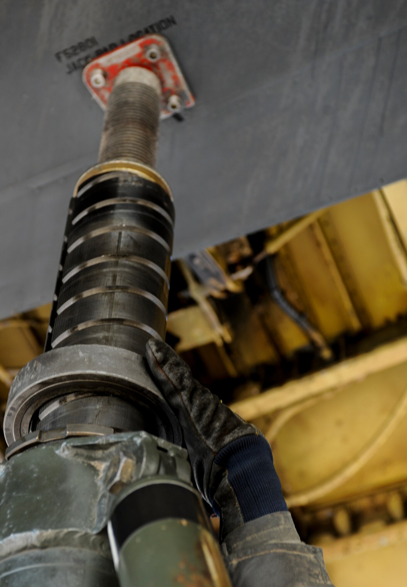 Airman 1st Class Zachary Jensen, 5th Maintenance Squadron repair and reclamation journeyman, adjusts a hydraulic jack under the wing of a B-52H Stratofortress on Minot Air Force Base, N.D., Feb. 4, 2015. Jensen and his team use the jack during a tip gear operation check. Tip gear protects the wings of the aircraft from damage as they flex during landing. (U.S. Air Force photo/Senior Airman Stephanie Morris)