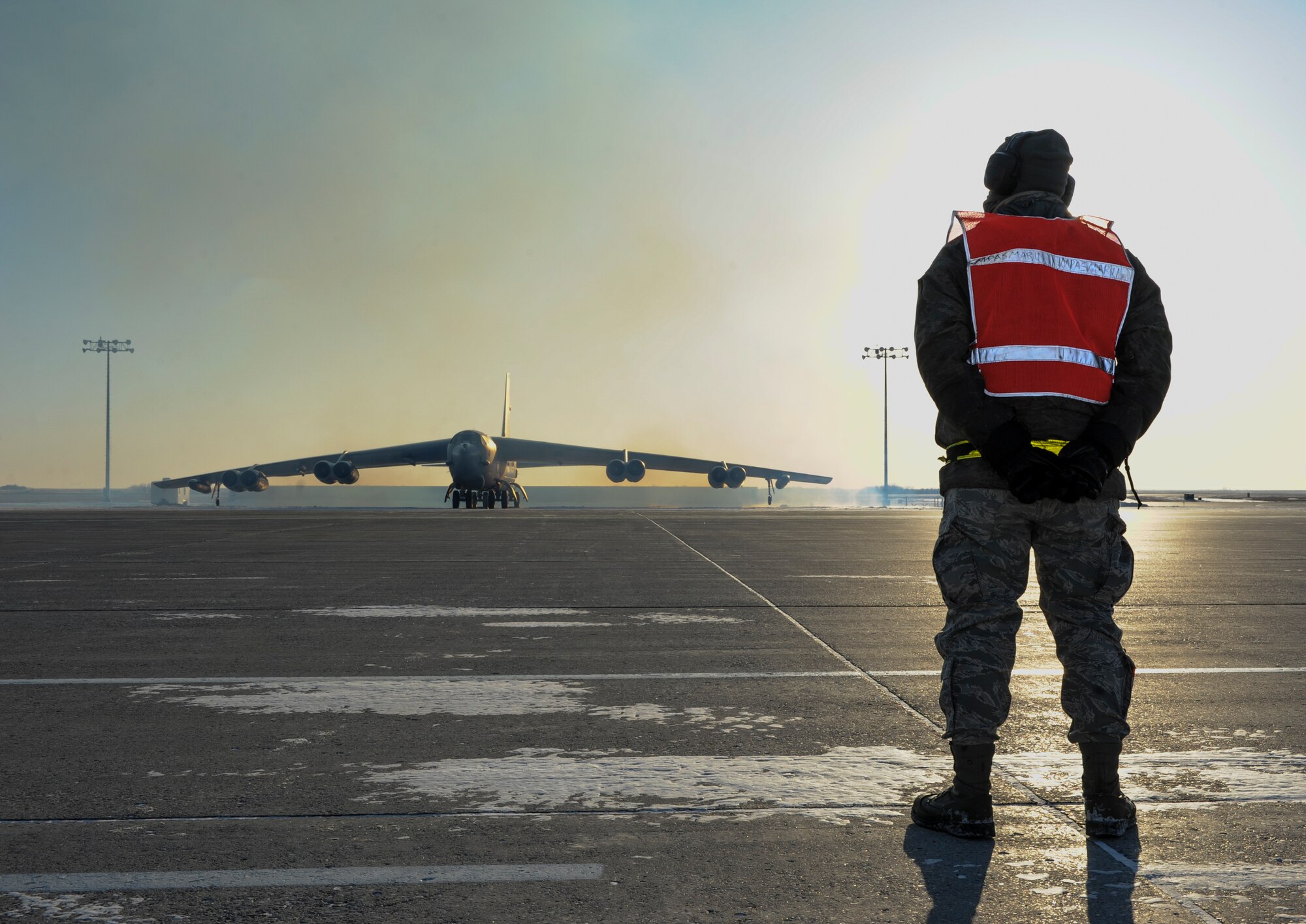 Airman 1st Class Yousef Sakhnini, 5th Aircraft Maintenance Squadron crew chief, waits to give taxi directions to a B-52H Stratofortress on Minot Air Force Base, N.D., Feb. 4, 2015. Before taxi Sakhnini performed preflight checks on the engines and operating systems of the aircraft with the assistance of aircrew members and other crew chiefs. (U.S. Air Force photo/Senior Airman Stephanie Morris)