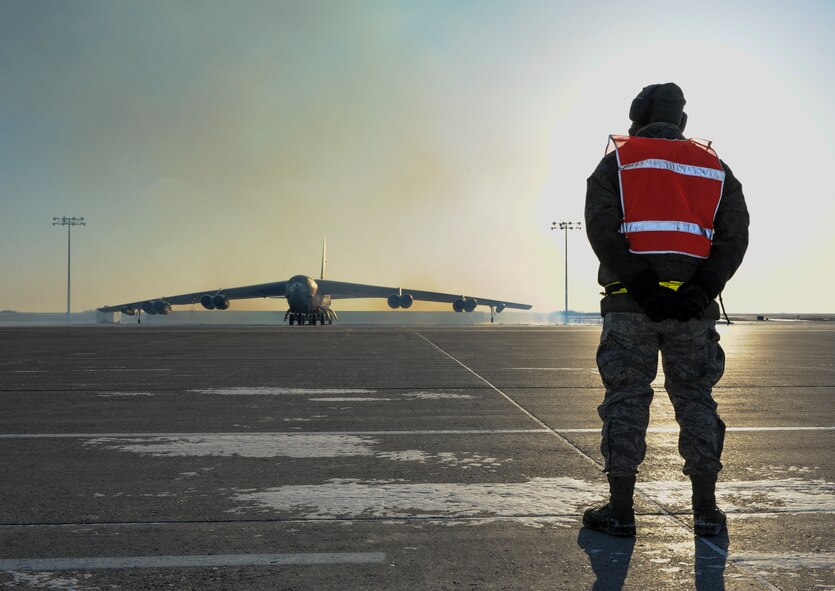 Airman 1st Class Yousef Sakhnini, 5th Aircraft Maintenance Squadron crew chief, waits to give taxi directions to a B-52H Stratofortress on Minot Air Force Base, N.D., Feb. 4, 2015. Before taxi Sakhnini performed preflight checks on the engines and operating systems of the aircraft with the assistance of aircrew members and other crew chiefs. (U.S. Air Force photo/Senior Airman Stephanie Morris)