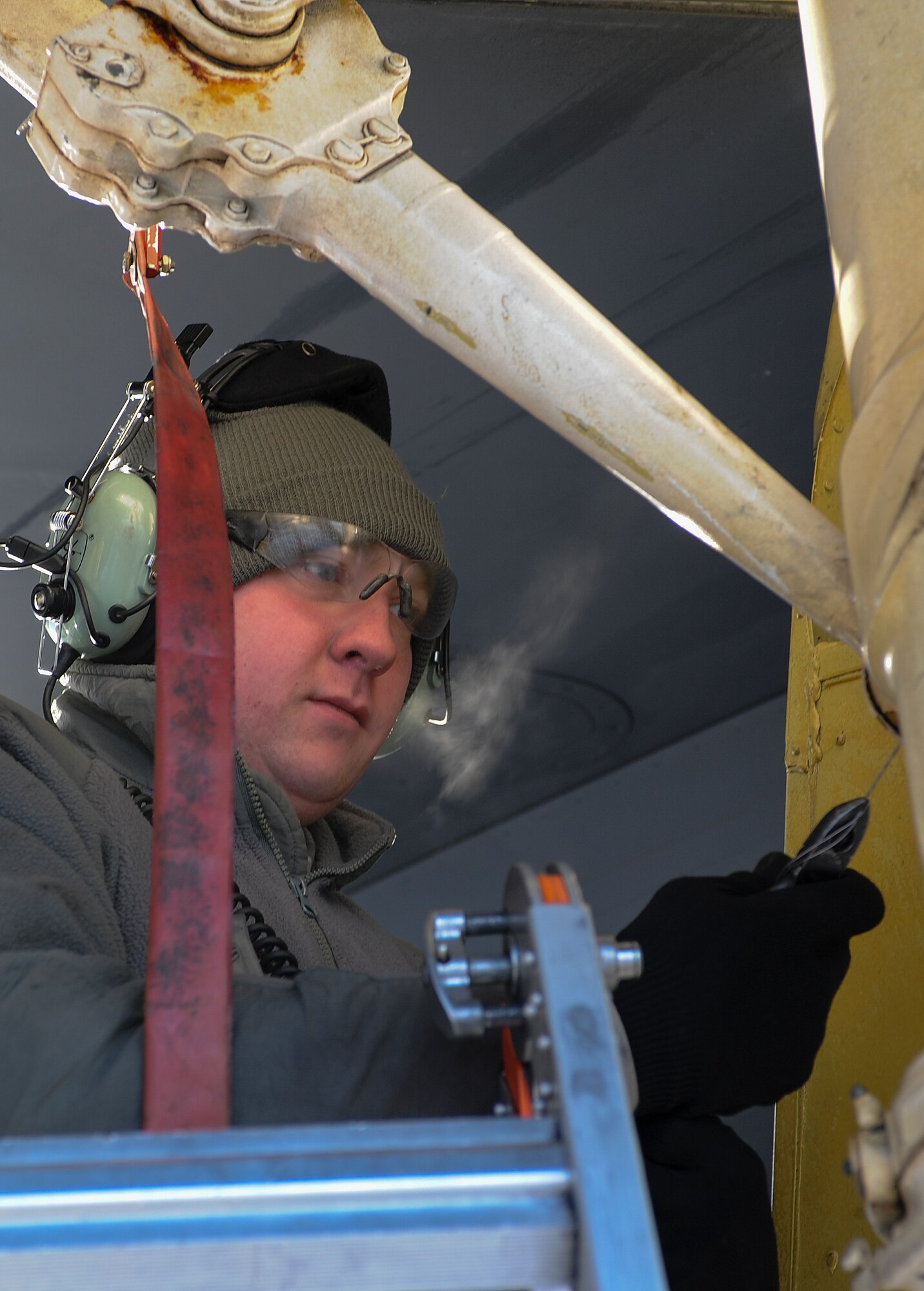 Airman 1st Class Trenton Broge, 5th Aircraft Maintenance Squadron crew chief, works on landing gear on the wing of a B-52H Stratofortress on Minot Air Force Base, N.D., Feb. 4, 2015. Crew chiefs work diligently before takeoff and after landing to ensure their aircraft are in perfect flying condition. (U.S. Air Force photo/Senior Airman Stephanie Morris)