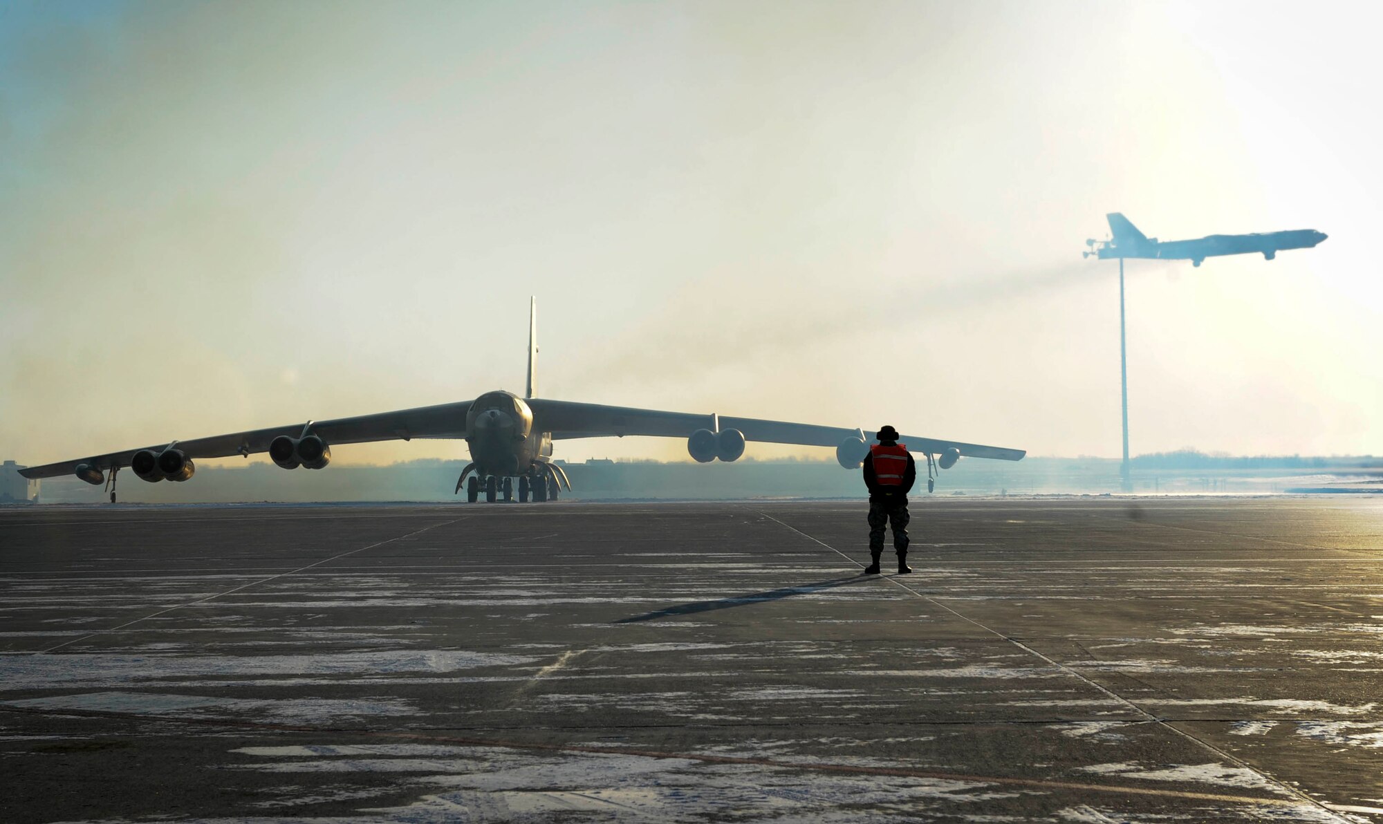 A B-52H Stratofortress takes flight behind another aircraft waiting to taxi on Minot Air Force Base, N.D., Feb. 4, 2015. Minot currently has 26 B-52H Stratofortresses assigned to the base. (U.S. Air Force photo/Senior Airman Stephanie Morris)