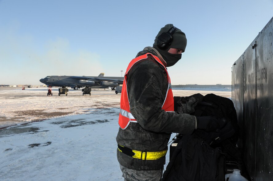 Airman 1st Class Yousef Sakhnini, 5th Aircraft Maintenance Squadron crew chief, retrieves a second pair of gloves from his bag on Minot Air Force Base, N.D., Feb. 4, 2015. While working on the flightline, crew chiefs often double up on their cold weather gear to combat Minot’s notoriously low temperatures. (U.S. Air Force photo/Senior Airman Stephanie Morris)