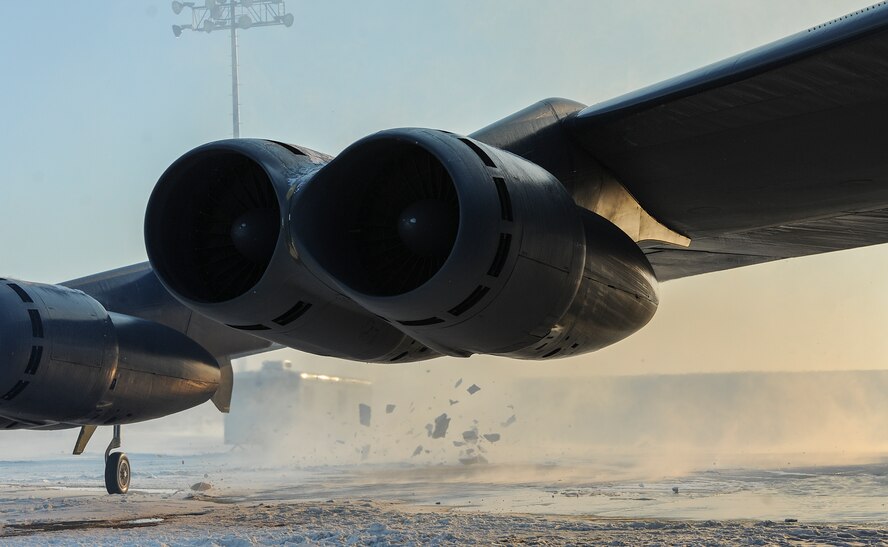 The engines of a B-52H Stratofortress blast away snow on the flightline on Minot Air Force Base, N.D., Feb. 4, 2015. During start up, maintenance Airmen and aircrew members must remain vigilant to avoid injury from debri and blowing snow. (U.S. Air Force photo/Senior Airman Stephanie Morris)
