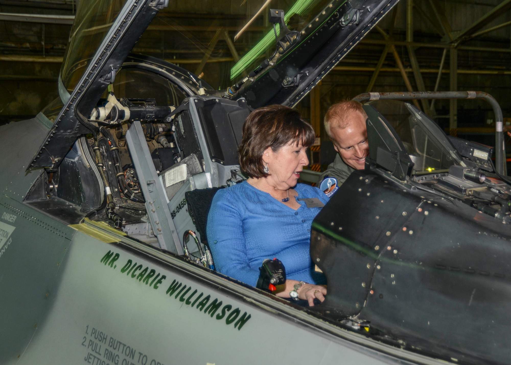 Barb Buus, Board of Equalization Member George Runner's office and 445th Flight Test Squadron honorary commander, sits in the cockpit of an F-16 at the 416th Flight Test Squadron. Each honorary commander was offered a chance to sit in the cockpit of the fighter. They were briefed on the aircraft's systems like the auto air/ground collision avoidance software. (U.S. Air Force photo by Rebecca Amber)