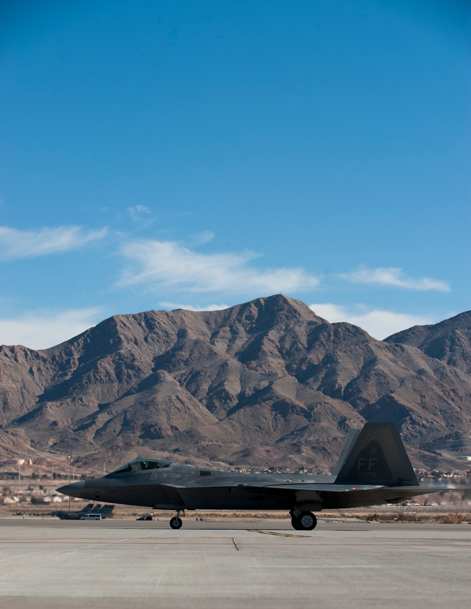 An F-22 Raptor assigned to the 94th Fighter Squadron, Joint Base Langley-Eustis, Va., taxis to the runway during Red Flag 15-1 at Nellis Air Force Base, Nev., Feb. 6, 2015. Red Flag provided combat training in a degraded and operationally limited environment making the training missions as realistic as possible. (U.S. Air Force photo by Senior Airman Thomas Spangler)
