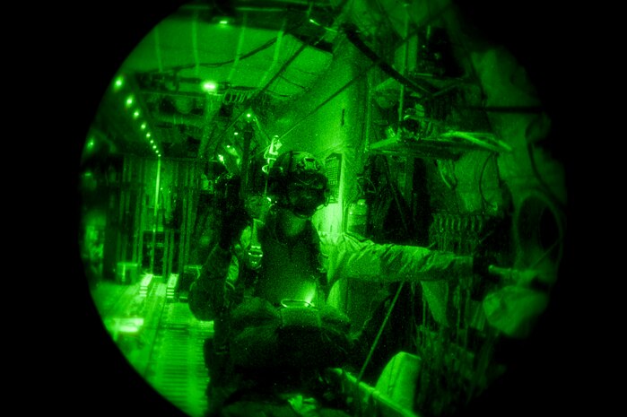 Tech. Sgt. Dave Scarborough, 58th Rescue Squadron Survival Evasion Resistance and Escape specialist, walks to the door of a Royal Australian air force C-130J Super Hercules from 37 Squadron, Richmond, Australia, before performing a static line jump during Red Flag 15-1, over the Nevada Test and Training Range, Feb. 9, 2015. Training missions between the U.S. and allied nations increase interoperability as well as mission effectiveness for future real world missions where allied nations may be required to work with each other. (U.S. Air Force photo by Senior Airman Thomas Spangler)