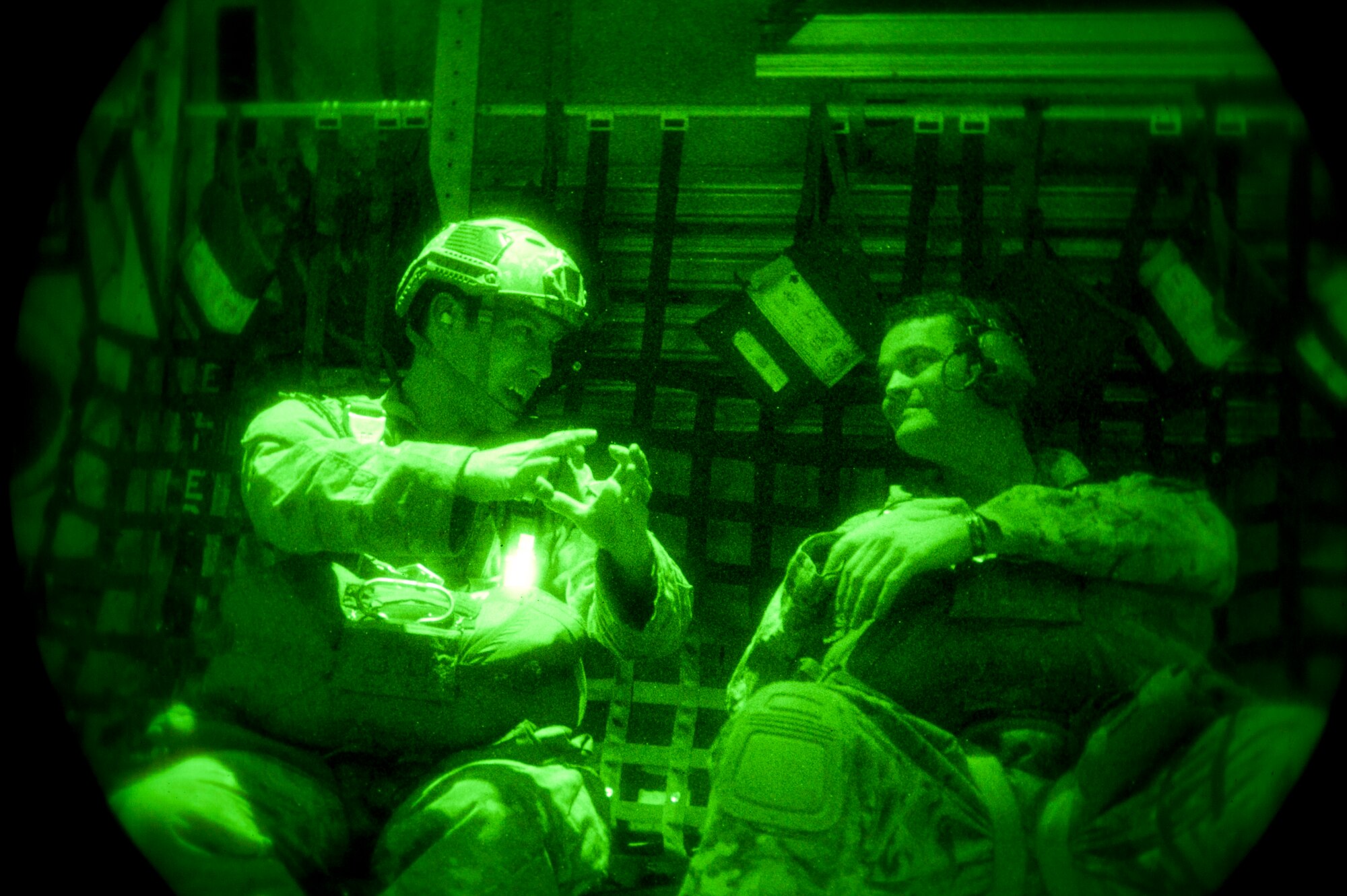 Staff Sgt. Eric McNair (left), a Survival Evasion Resistance and Escape specialist assigned to the 19th Operations Support Squadron, Little Rock Air Force Base, Ark., and Tech. Sgt. Dave Scarborough, 58th Rescue Squadron SERE specialist, prepare to perform a static line jump from a Royal Australian air force C-130J Super Hercules from 37 Squadron, Richmond, Australia, during Red Flag 15-1 over the Nevada Test and Training Range, Feb. 9, 2015. Red Flag provides the opportunity for U.S. and allied forces to train together for future real world conflicts where they may be required to work together. (U.S. Air Force photo by Senior Airman Thomas Spangler)