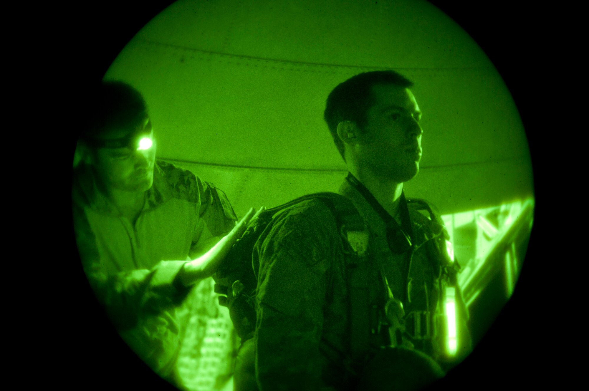 Tech. Sgt. Dave Scarborough (left), 58th Rescue Squadron Survival Evasion Resistance and Escape specialist, checks the parachute of Staff Sgt. Eric McNair, a SERE specialist assigned to the 19th Operations Support Squadron, Little Rock Air Force Base, Ark., before a night training exercise during Red Flag 15-1 at Nellis AFB, Nev., Feb. 9, 2015. Red Flag night missions present the additional challenge of low visibility, testing aircrew’s ability to execute the mission at any hour in a contested and degraded environment. (U.S. Air Force photo by Senior Airman Thomas Spangler)