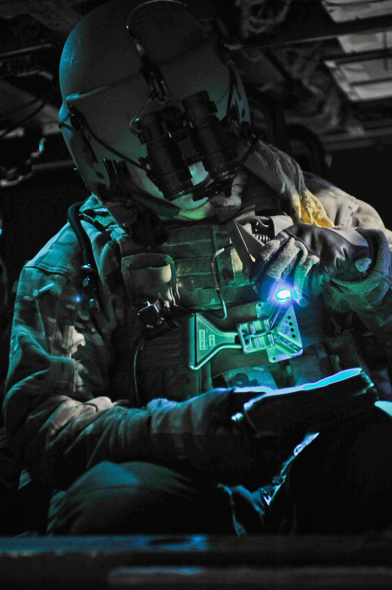 Airman 1st Class Daniel Cowan, 66th Rescue Squadron flight engineer, runs through the HH-60G Pave Hawk preflight checklist prior to a mission over the Nevada Test and Training Range, Nev. Feb. 5, 2015. Red Flag missions are conducted on the 2.9 million acres Nevada Test and Training Range with 1,900 possible targets, realistic threat systems and opposing enemy forces. (U.S. Air Force photo by Staff Sgt. Darlene Seltmann)