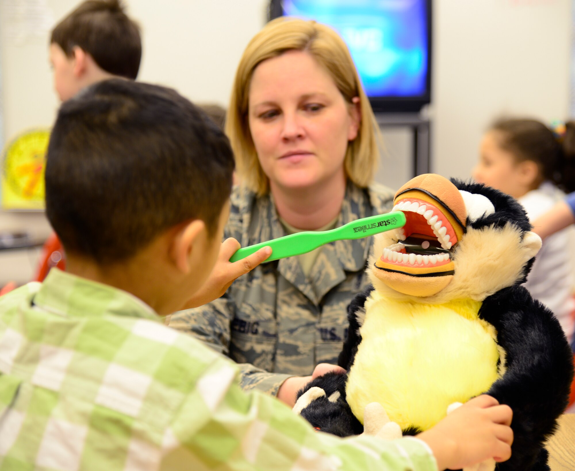 U.S. Air Force Master Sgt. Susan Liebig, a 354th Medical Operations Squadron hygienist, watches a child demonstrate proper teeth cleaning techniques during a National Children’s Dental Health month demonstration at Anderson Elementary, Eielson Air Force Base, Alaska, Feb. 10, 2015. Icemen from the dental office explained the importance of staying away from sugary foods, eating a healthy diet, how toothpaste is a vitamin for teeth and gave brushing and flossing techniques. (U.S. Air Force photo by Senior Airman Racheal E. Watson/Released)