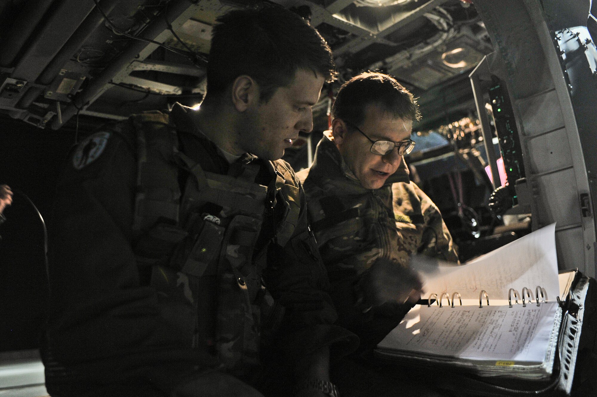 Capt Robert Louder, 66th Rescue Squadron HH-60G Pave Hawk pilot and Airman 1st Class Daniel Cowan, 66th RQS flight engineer prepare for a mission over the Nevada Test and Training Range, Nev. Feb. 5, 2015. Search and rescue operations during Red Flag improve efficiency and readiness for future real world operations. The night missions present the additional challenge of low visibility, testing aircrew’s ability to execute the mission at any hour in a contested and degraded environment. (U.S. Air Force photo by Staff Sgt. Darlene Seltmann)